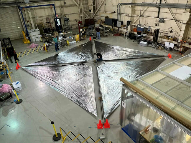 Engineers at NASA's Langley Research Center test deployment of the Advanced Composite Solar Sail System's solar sail. The unfurled solar sail is approximately 30 feet (about 9 meters) on a side. Since solar radiation pressure is small, the solar sail must be large to efficiently generate thrust. Engineers at NASA's Langley Research Center test deployment of the Advanced Composite Solar Sail System's solar sail. The unfurled solar sail is approximately 30 feet (about 9 meters) on a side. Since solar radiation pressure is small, the solar sail must be large to efficiently generate thrust